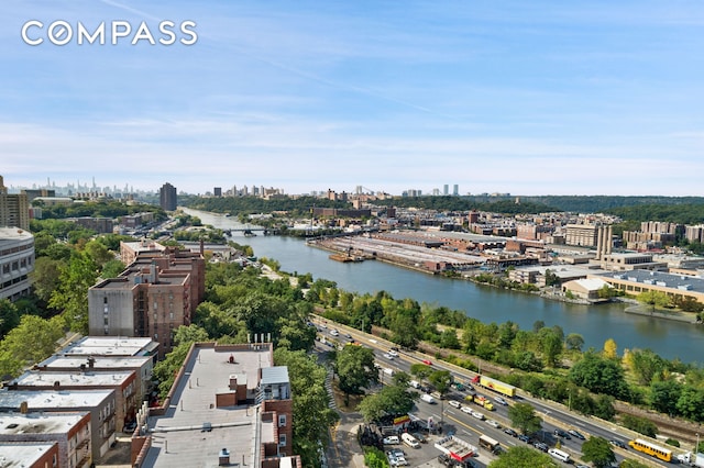 birds eye view of property featuring a water view and a city view