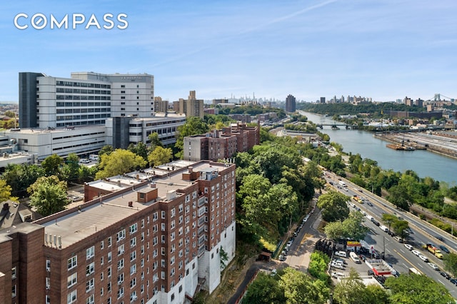 birds eye view of property featuring a view of city and a water view