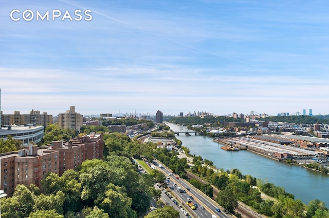 birds eye view of property with a view of city and a water view