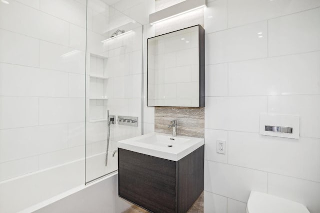 full bathroom featuring decorative backsplash, tub / shower combination, toilet, and vanity