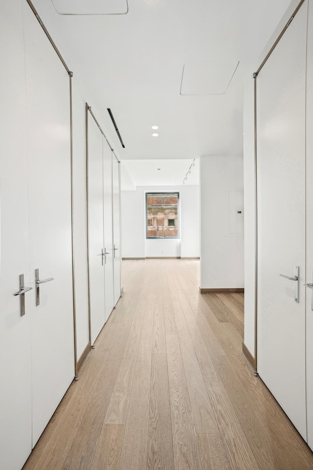 corridor featuring light wood-style flooring