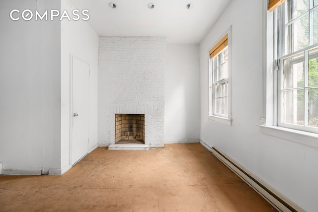 unfurnished living room featuring a baseboard radiator and a large fireplace