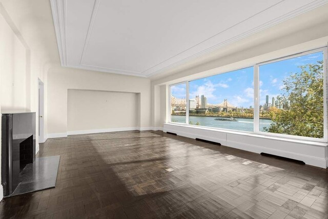 spare room featuring ornamental molding and light hardwood / wood-style floors