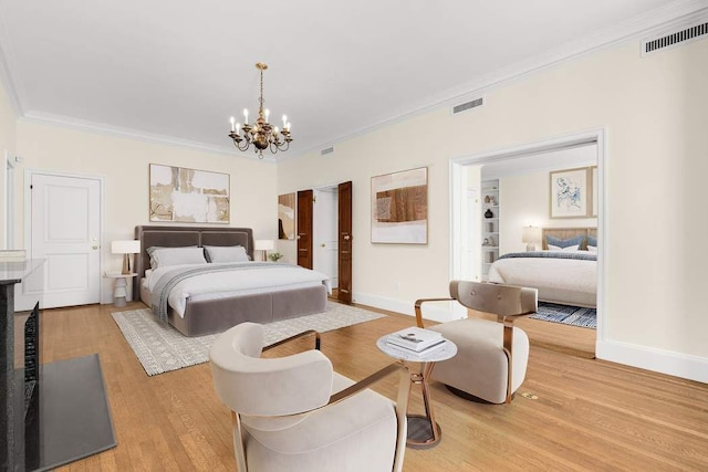 bedroom with crown molding, hardwood / wood-style floors, and a notable chandelier