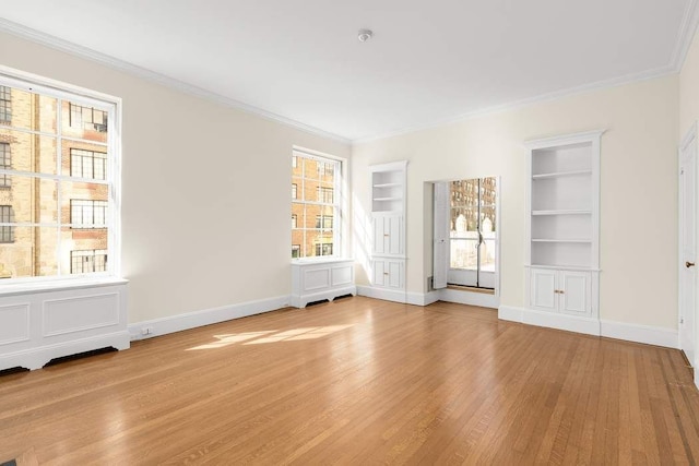 bedroom with crown molding and light hardwood / wood-style floors