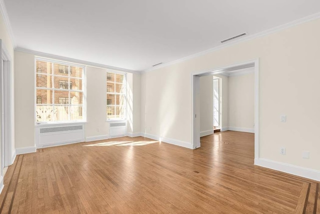 bedroom featuring light wood-type flooring, crown molding, and an inviting chandelier