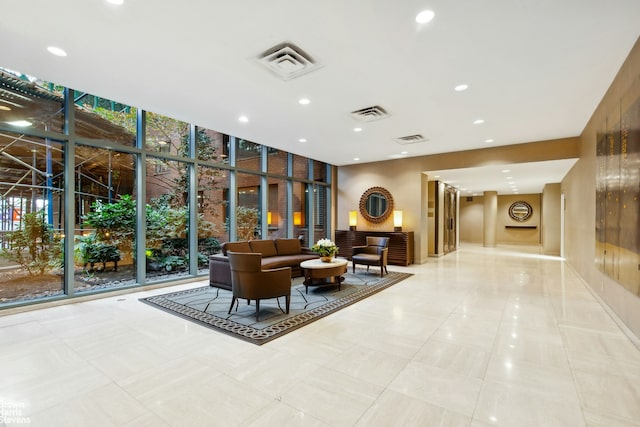 building lobby featuring floor to ceiling windows and recessed lighting