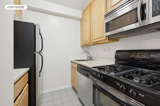 1725 York Ave Unit 14A, New York City, NY 10128 - kitchen with appliances with stainless steel finishes, light brown cabinetry, light countertops, light tile patterned floors, and a sink