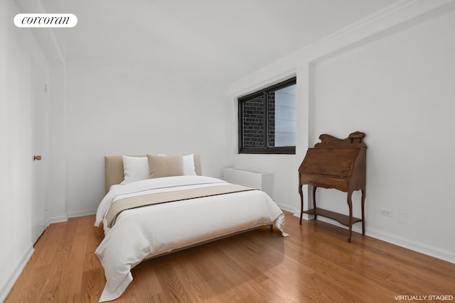 bedroom with visible vents, baseboards, and light wood-style floors