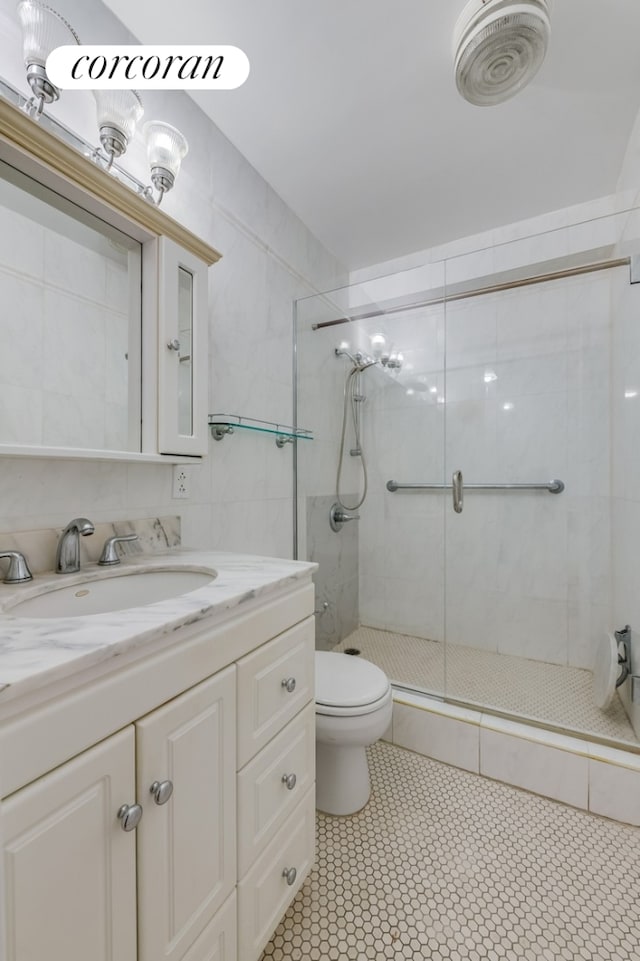 1725 York Ave Unit 14A, New York City, NY 10128 - bathroom featuring a stall shower, toilet, and vanity