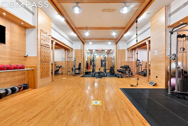 gym with wooden walls and wood-type flooring