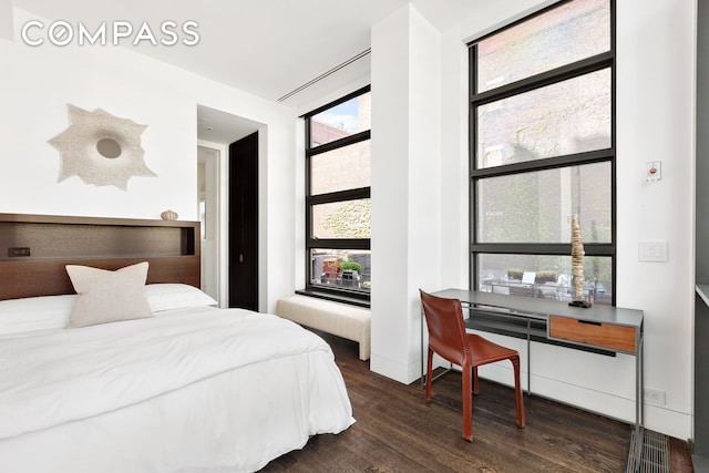 bedroom featuring dark wood finished floors and baseboards