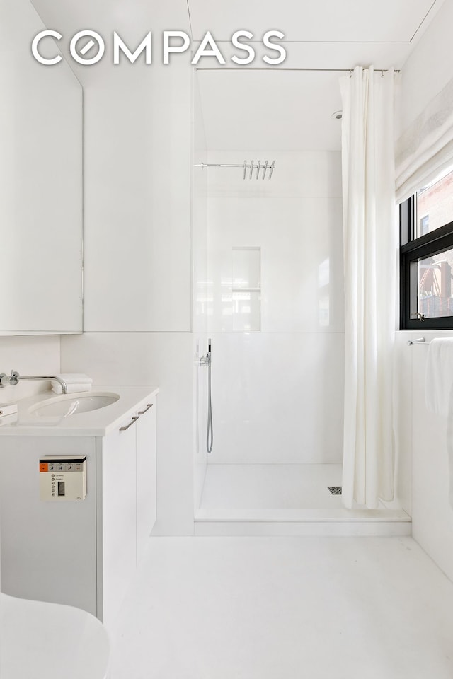 bathroom with vanity, a shower stall, and toilet