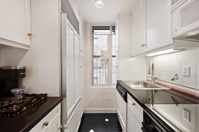 12 E 97th St Unit 8E, New York City, NY 10029 - kitchen with white appliances, dark countertops, white cabinets, and recessed lighting