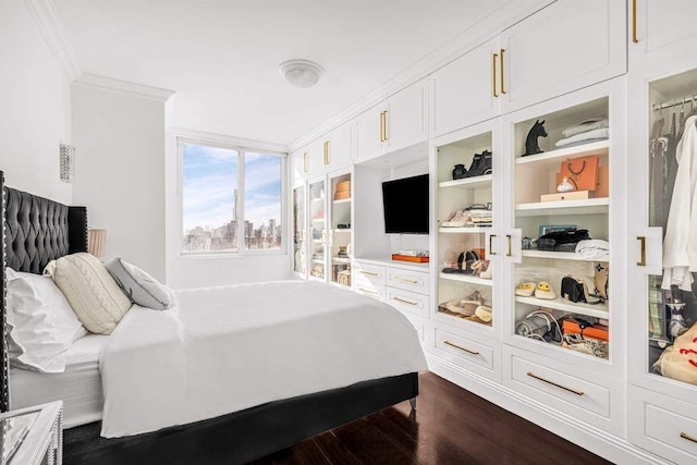 bedroom featuring ornamental molding and dark wood finished floors