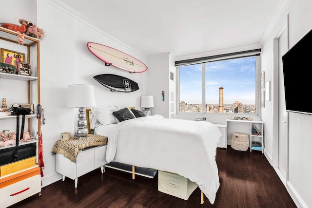 bedroom with dark hardwood / wood-style flooring and ornamental molding