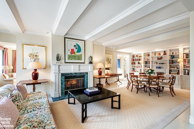 living room featuring crown molding, beamed ceiling, and a premium fireplace