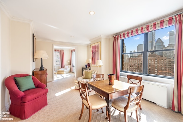 dining space with a view of city, ornamental molding, and light colored carpet