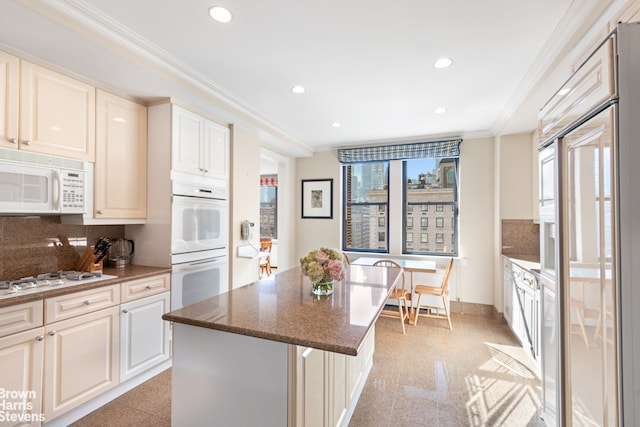 kitchen featuring decorative backsplash, crown molding, a center island, recessed lighting, and white appliances