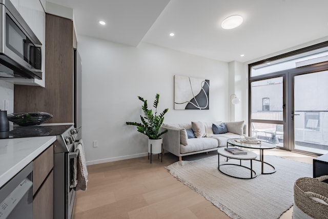 11-52 44th Dr Unit 2-A, New York City, NY 11101 - living area featuring plenty of natural light, light wood-style flooring, and recessed lighting