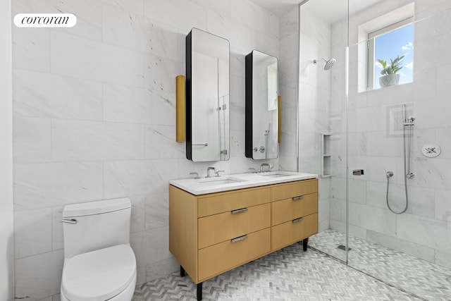 bathroom with double vanity, a sink, toilet, and a walk in shower