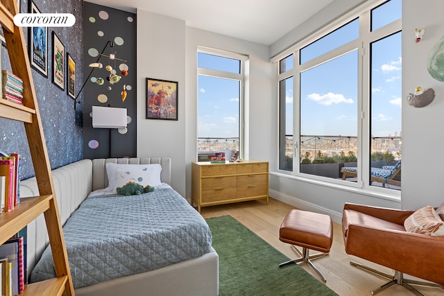 bedroom with baseboards and wood finished floors