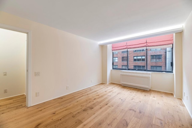 spare room with light hardwood / wood-style floors