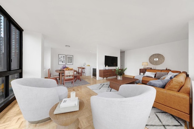 living room with expansive windows and light parquet floors