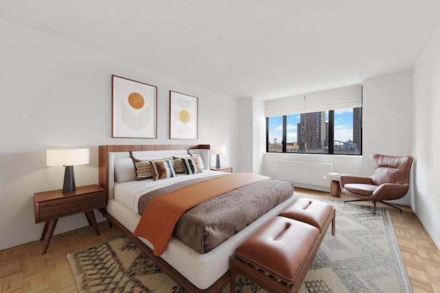 bedroom with light parquet floors