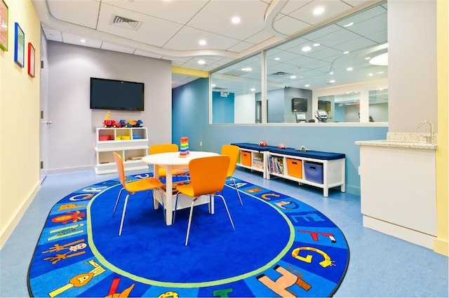 playroom with sink and a paneled ceiling