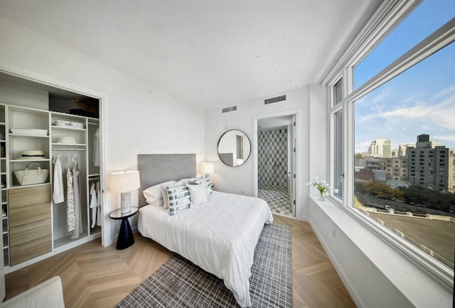 bedroom featuring a closet and light parquet floors