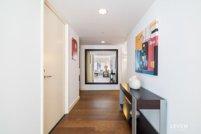 hall with baseboards, wood finished floors, and recessed lighting