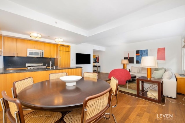 dining space with hardwood / wood-style flooring