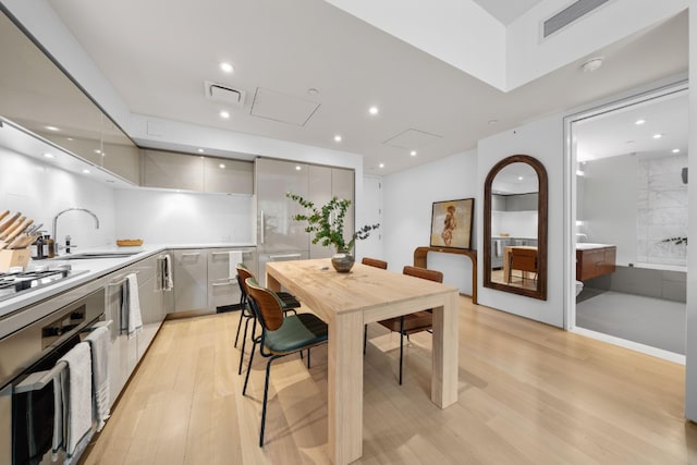 dining space with recessed lighting, visible vents, and light wood-style flooring