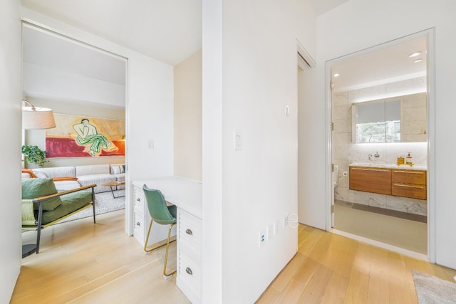 corridor featuring light wood finished floors