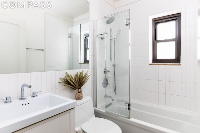 full bathroom featuring tasteful backsplash, tiled shower / bath, vanity, and toilet