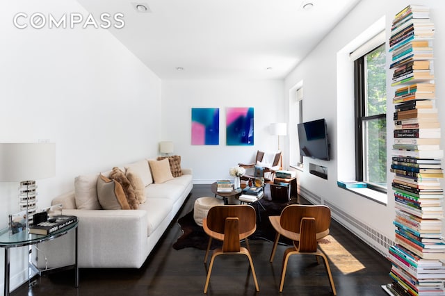 living room with baseboards and wood finished floors