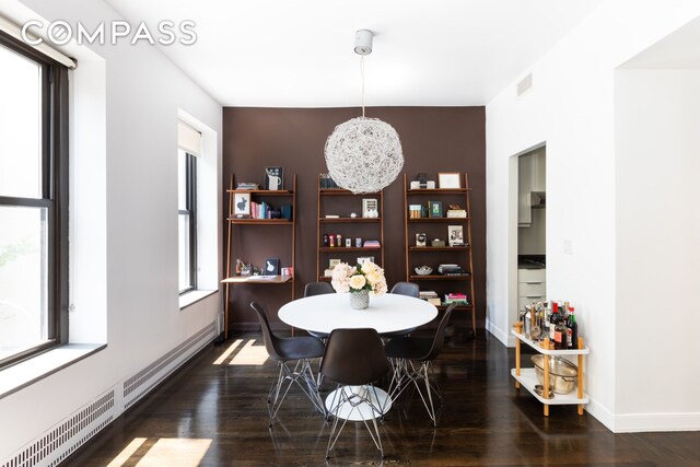 422 W 20th St Unit 3G, New York City, NY 10011 - dining room featuring a baseboard radiator, dark wood-style floors, and baseboards