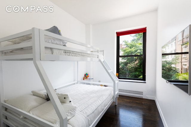 bedroom with visible vents, baseboards, and wood finished floors