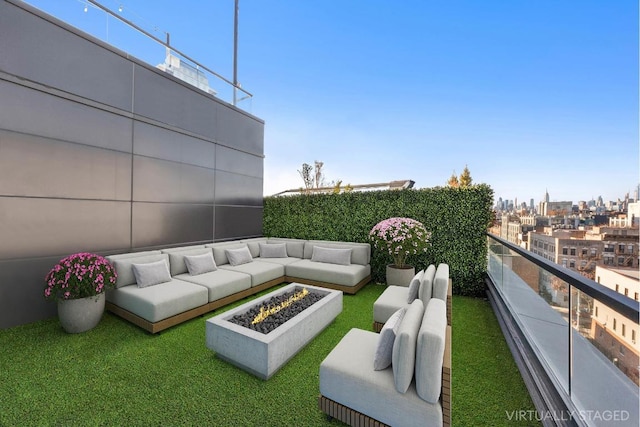 exterior space with an outdoor living space with a fire pit and a balcony