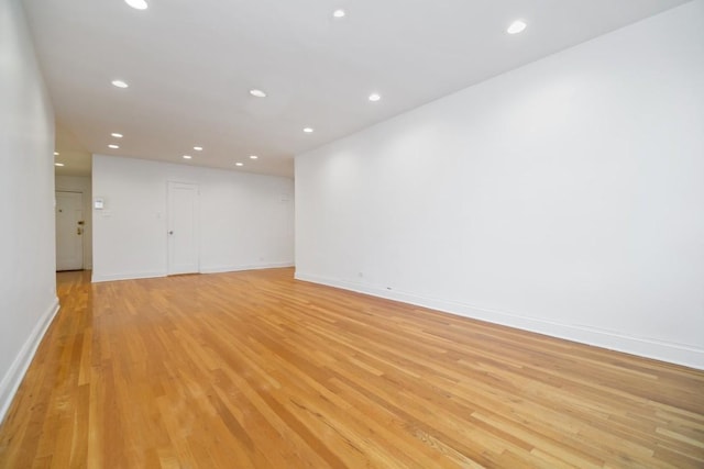 unfurnished room with light wood-type flooring