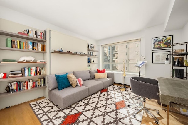 home office with light hardwood / wood-style floors