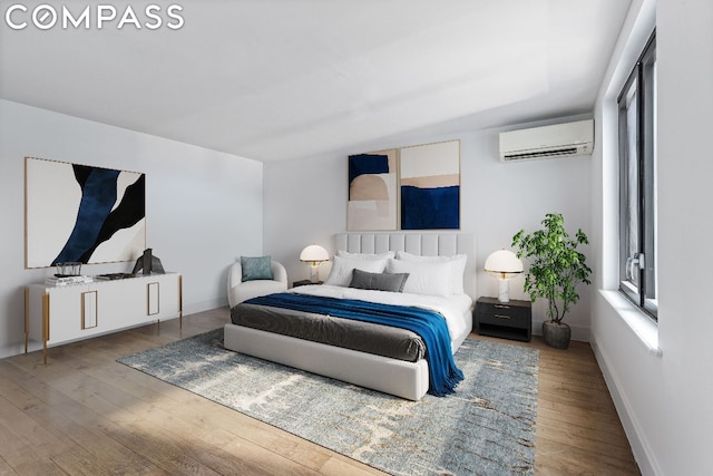 bedroom with a wall unit AC and hardwood / wood-style flooring