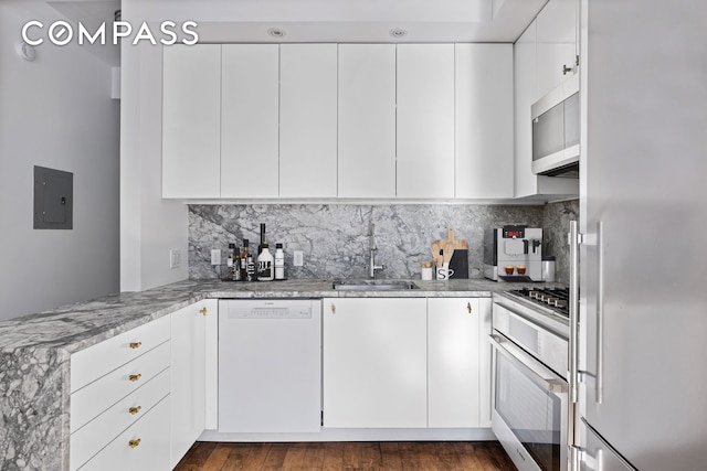 242 S 1st St Unit 4E, New York City, NY 11211 - kitchen featuring stainless steel appliances, a sink, light stone counters, and backsplash
