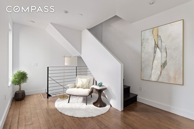 242 S 1st St Unit 4E, New York City, NY 11211 - living area featuring hardwood / wood-style floors, an upstairs landing, and baseboards