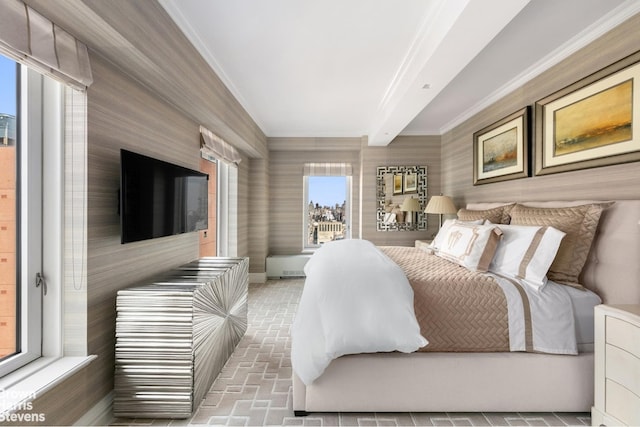 bedroom with brick floor, ornamental molding, and beam ceiling