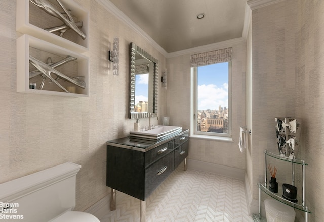 bathroom featuring toilet, a city view, vanity, baseboards, and crown molding