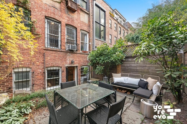 view of patio featuring outdoor dining area, outdoor lounge area, and fence