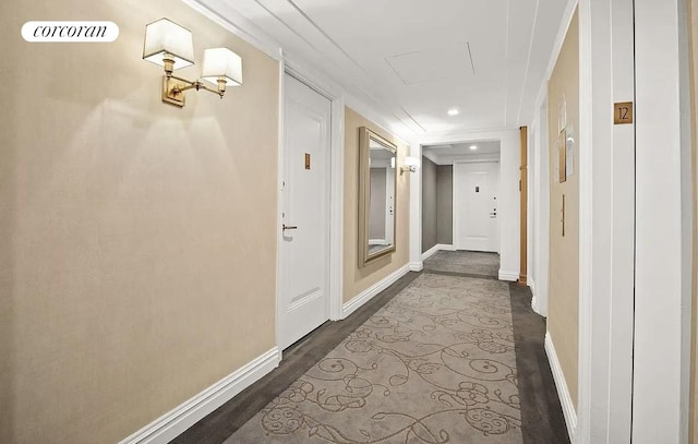 corridor with baseboards, dark wood finished floors, recessed lighting, and crown molding