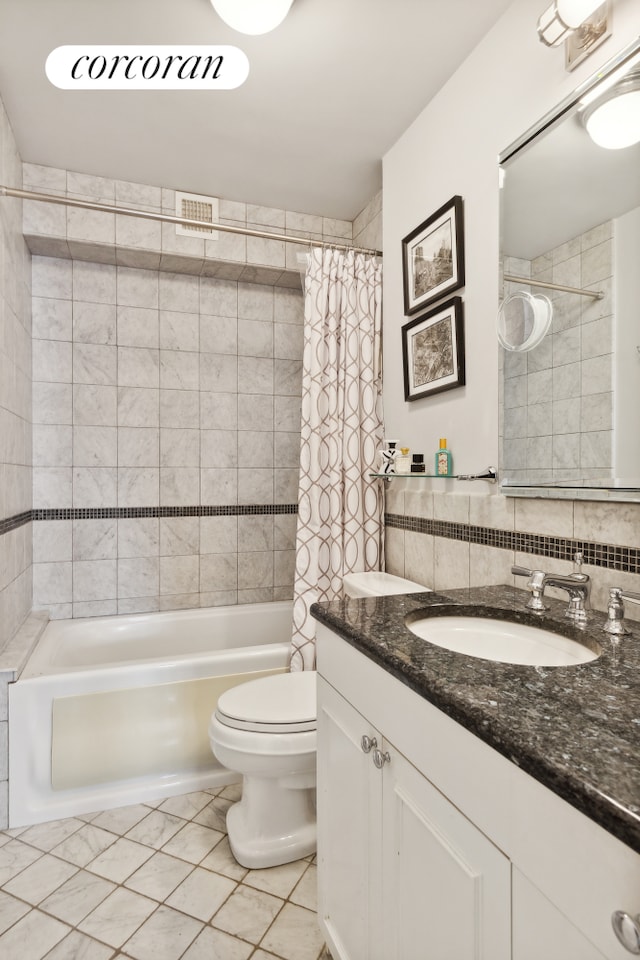 full bathroom with toilet, shower / bath combo with shower curtain, vanity, and tile patterned floors